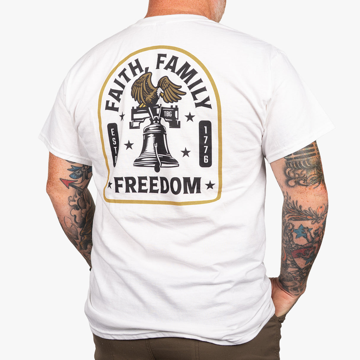 Men's white t-shirt featuring a Liberty Bell graphic with "Faith Family Freedom" text and eagle design on the back.