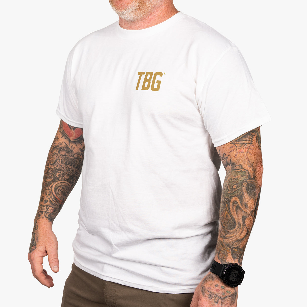 White t-shirt featuring "TBG" logo, designed for those who value faith, family, and freedom. Ideal for casual wear.