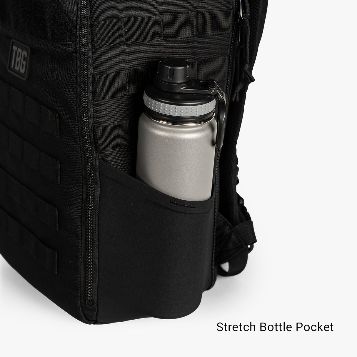 Black Daypack Mini featuring a stretch bottle pocket with a silver water bottle securely held inside.