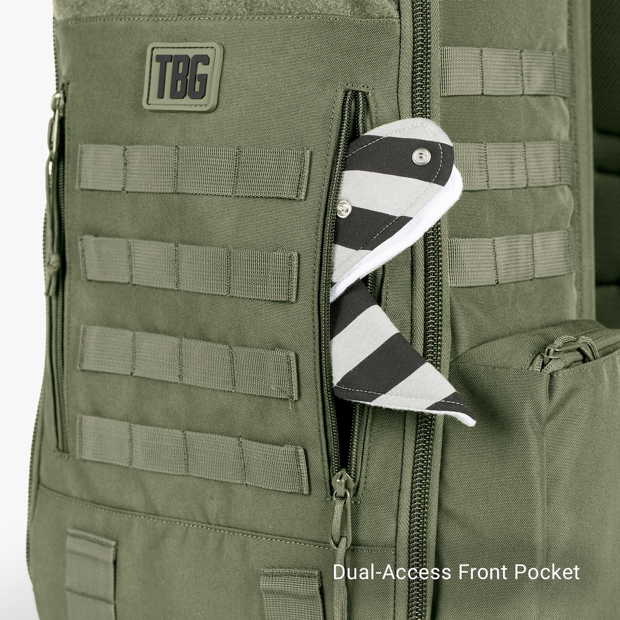 Green tactical daypack diaper bag with baby carrier bundle, featuring a dual-access front pocket and striped pacifier clip.