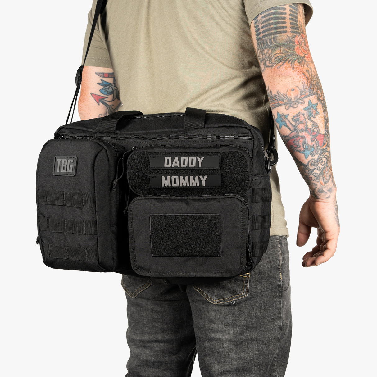 Black Deuce Diaper Bag and Baby Carrier bundle with labeled patches for daddy and mommy, designed for convenient parenting.