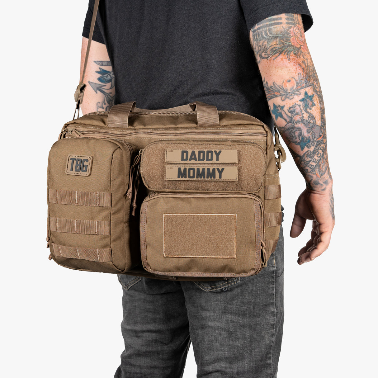 Tactical Baby Gear Deuce Diaper Bag and Baby Carrier bundle in tan with multiple compartments, patches, and adjustable straps.