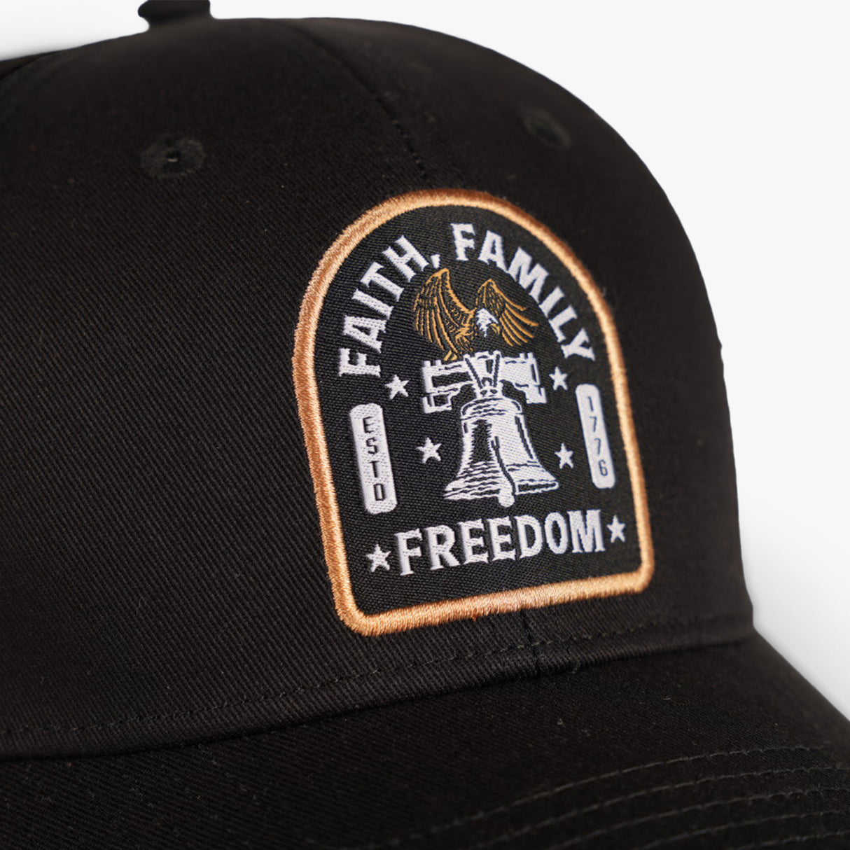 Low profile black hat featuring an embroidered patch with "Faith, Family, Freedom" and a bell design.