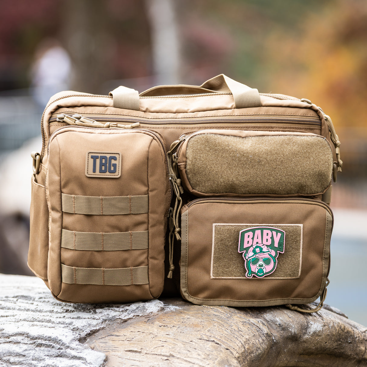 Rugged baby bag featuring a Baby Bear patch, multiple pockets, and military-inspired design for modern parents.