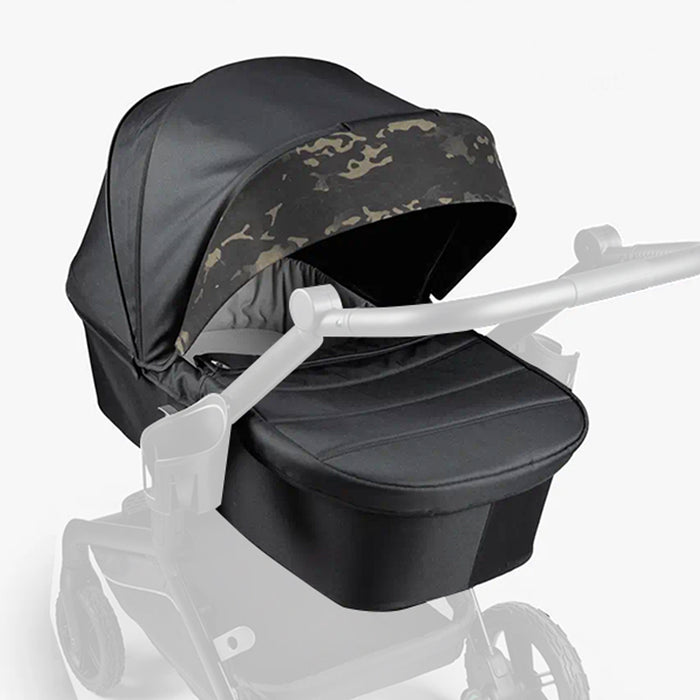 Black military-style stroller with camouflage canopy and white frame.