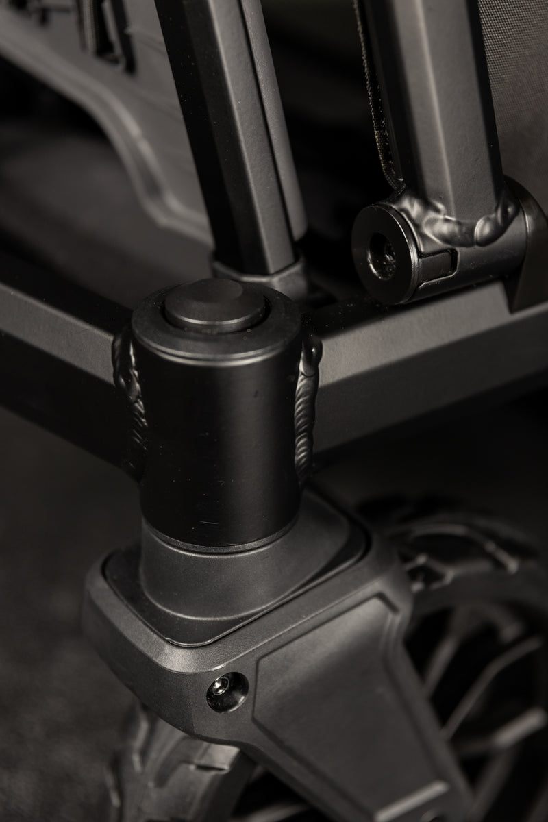 Close-up of a rugged stroller's black metal frame, featuring sturdy wheels and reinforced joints, perfect for active parents.