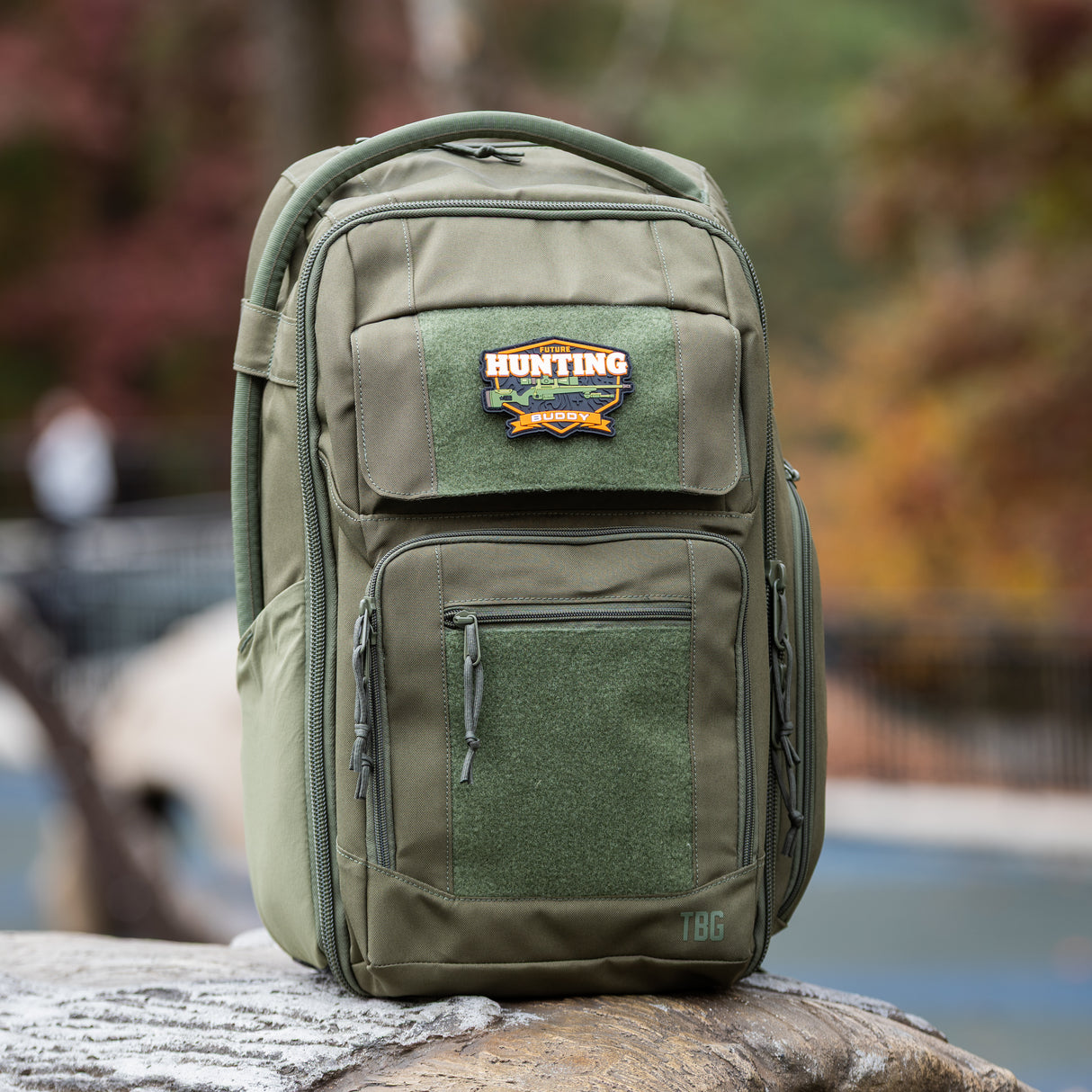 Tactical Baby Gear Future Hunting Buddy Patch on a rugged green backpack, designed for outdoor parenting adventures.