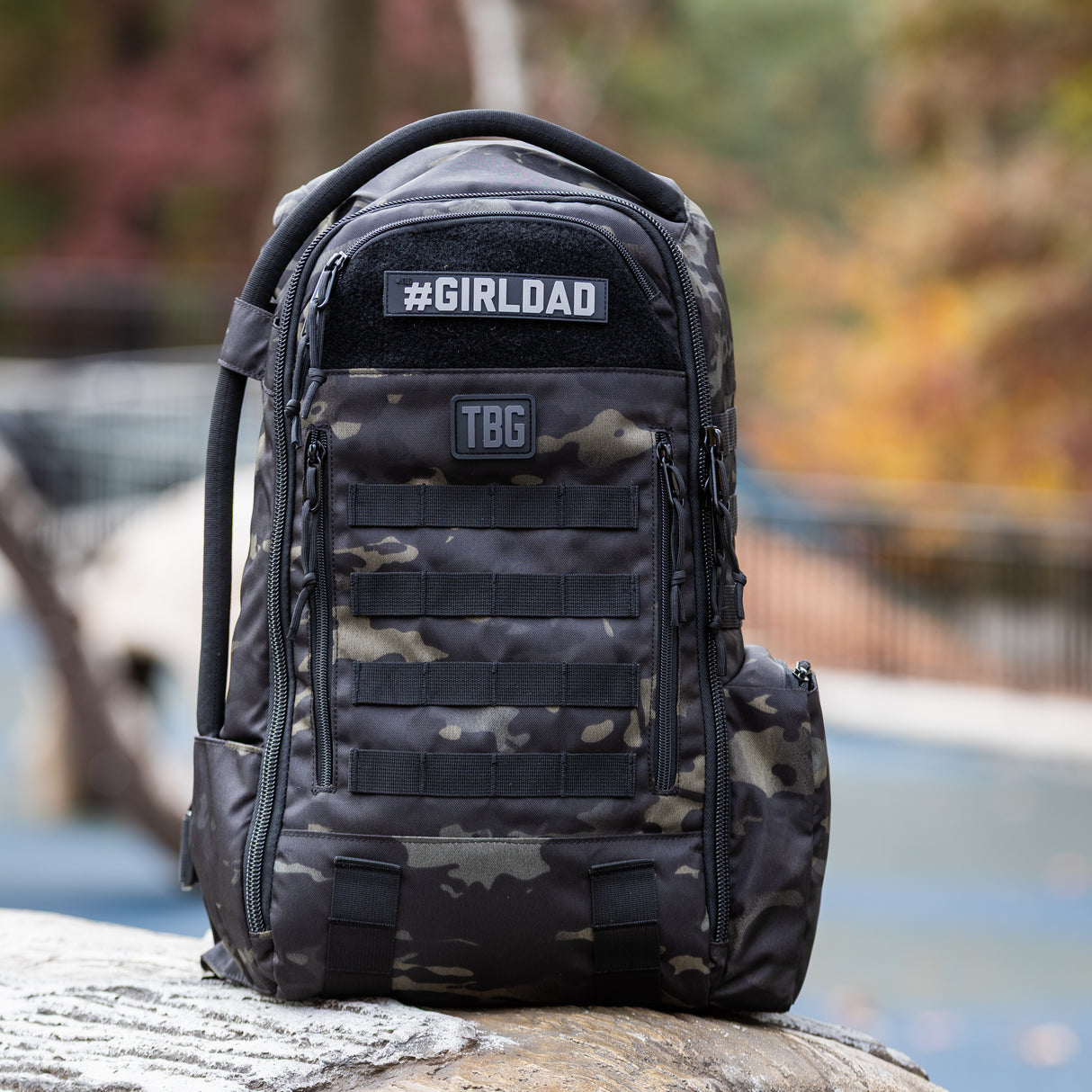 Tactical Baby Gear #GIRLDAD name tape patch on a rugged black camo backpack designed for modern parents.