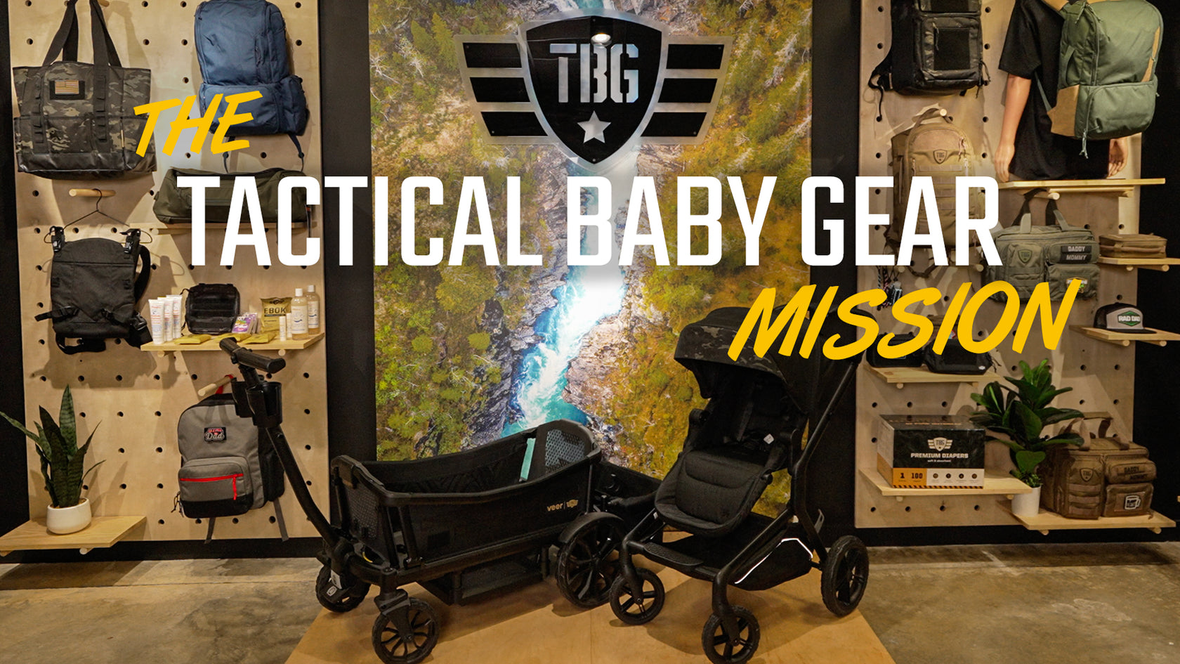 Display of tactical baby gear including strollers and bags in black and camouflage, set against a store backdrop.