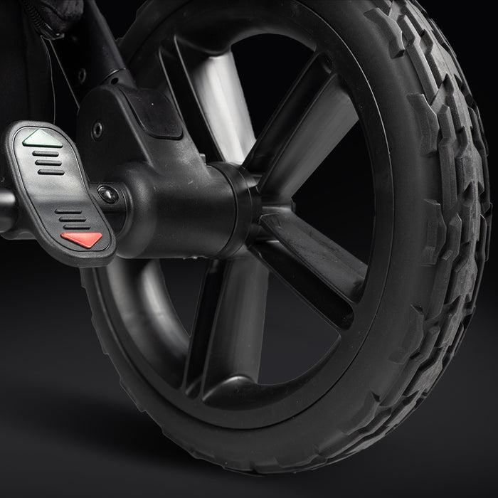 Close-up of a stroller's black rugged wheel with red and green indicators, emphasizing durability.