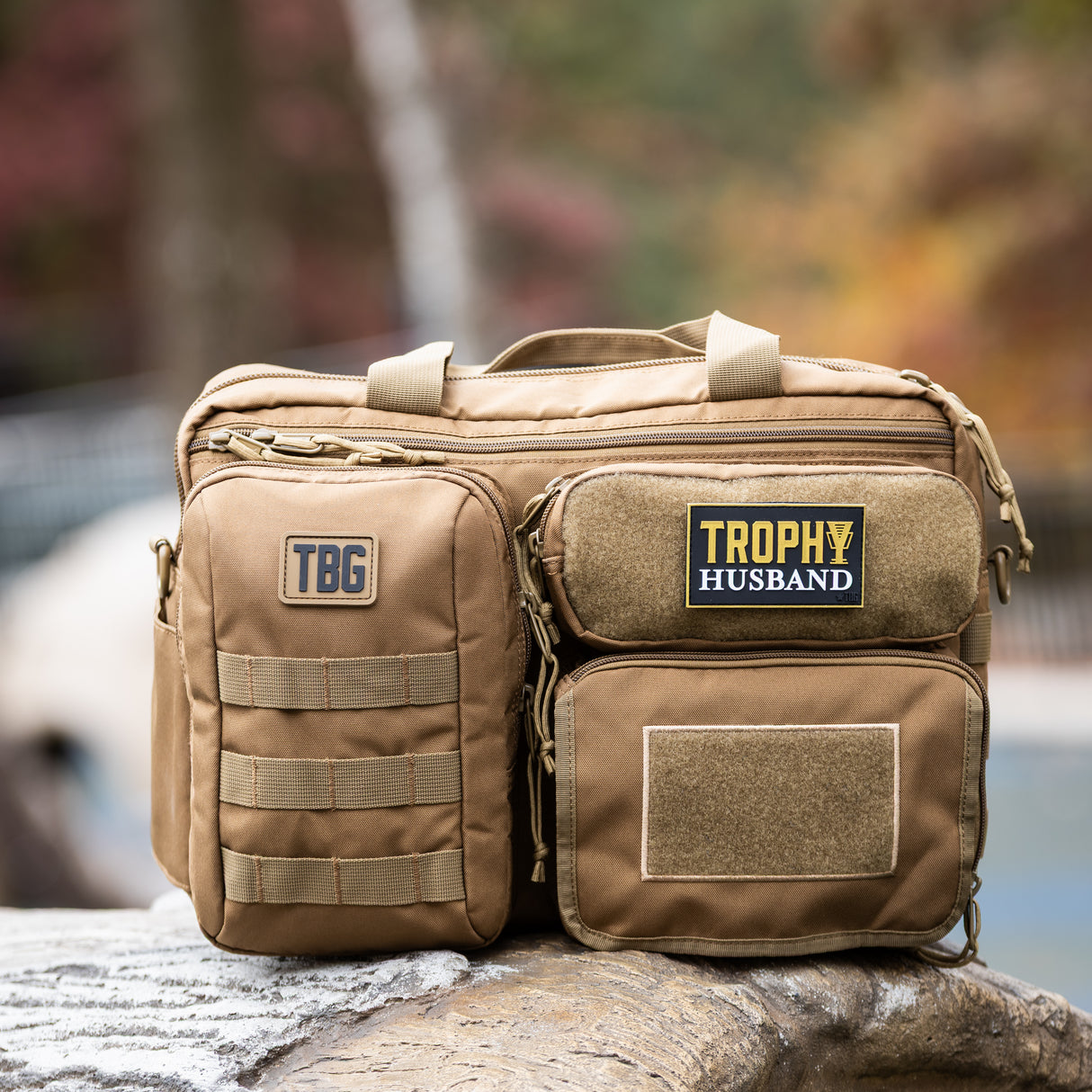 Tactical Baby Gear bag featuring a "Trophy Husband" patch, designed for rugged parenting and outdoor adventures.