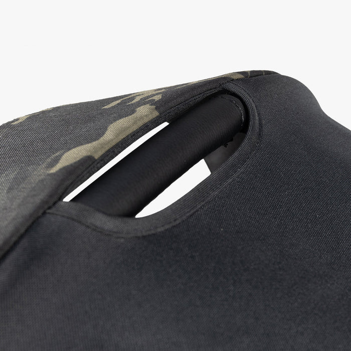 Close-up of a black, military-inspired diaper bag with camouflage detailing.