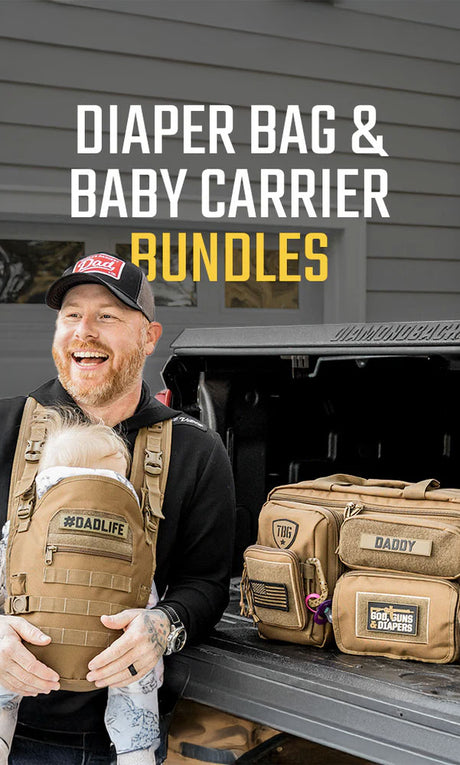 Man smiling, wearing a tan baby carrier, beside tan diaper bags marked with tactical and rugged design elements.