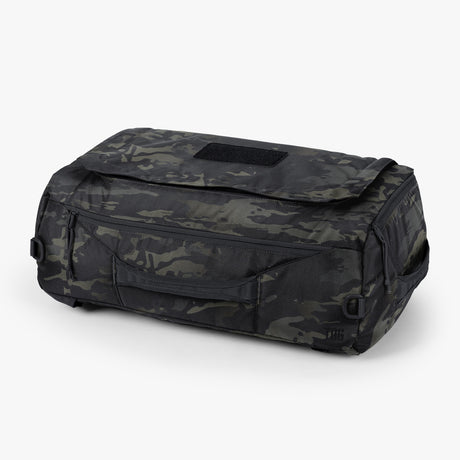 Duffle bag in multicam pattern with robust handles displayed on a neutral background.