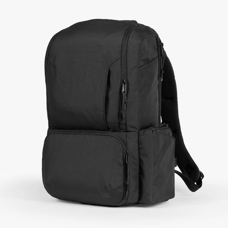 Black expedition diaper bag with multiple compartments, displayed against a white background.