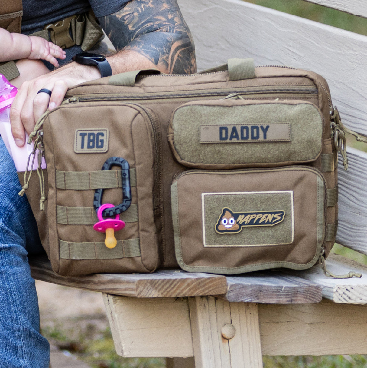Tactical Baby Gear diaper bag featuring the Poop Happens Patch, designed for rugged parenting on the go.