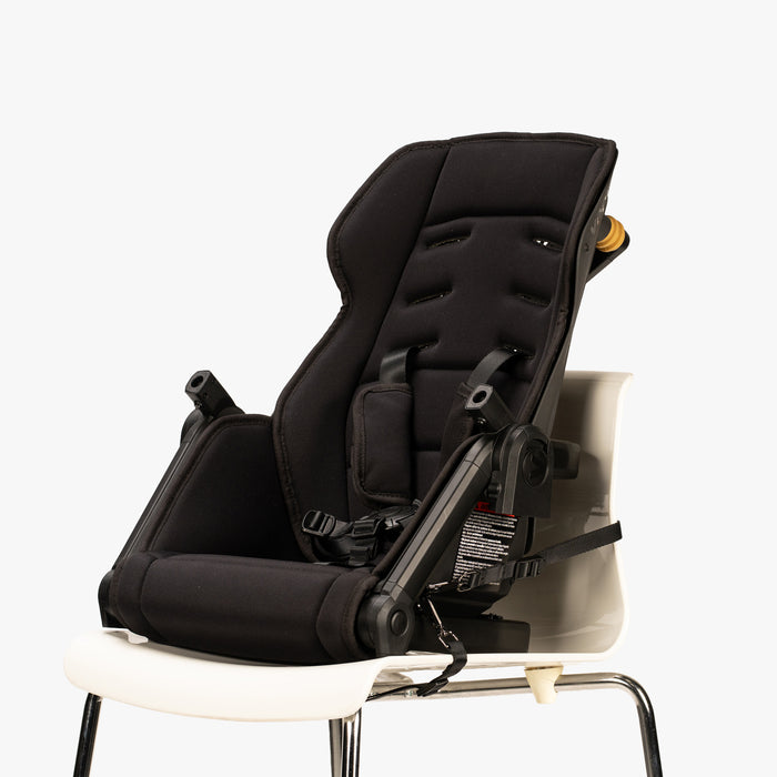 Baby carrier and portable seat combo from TBG, featuring adjustable straps and foldable design, displayed against a plain background.