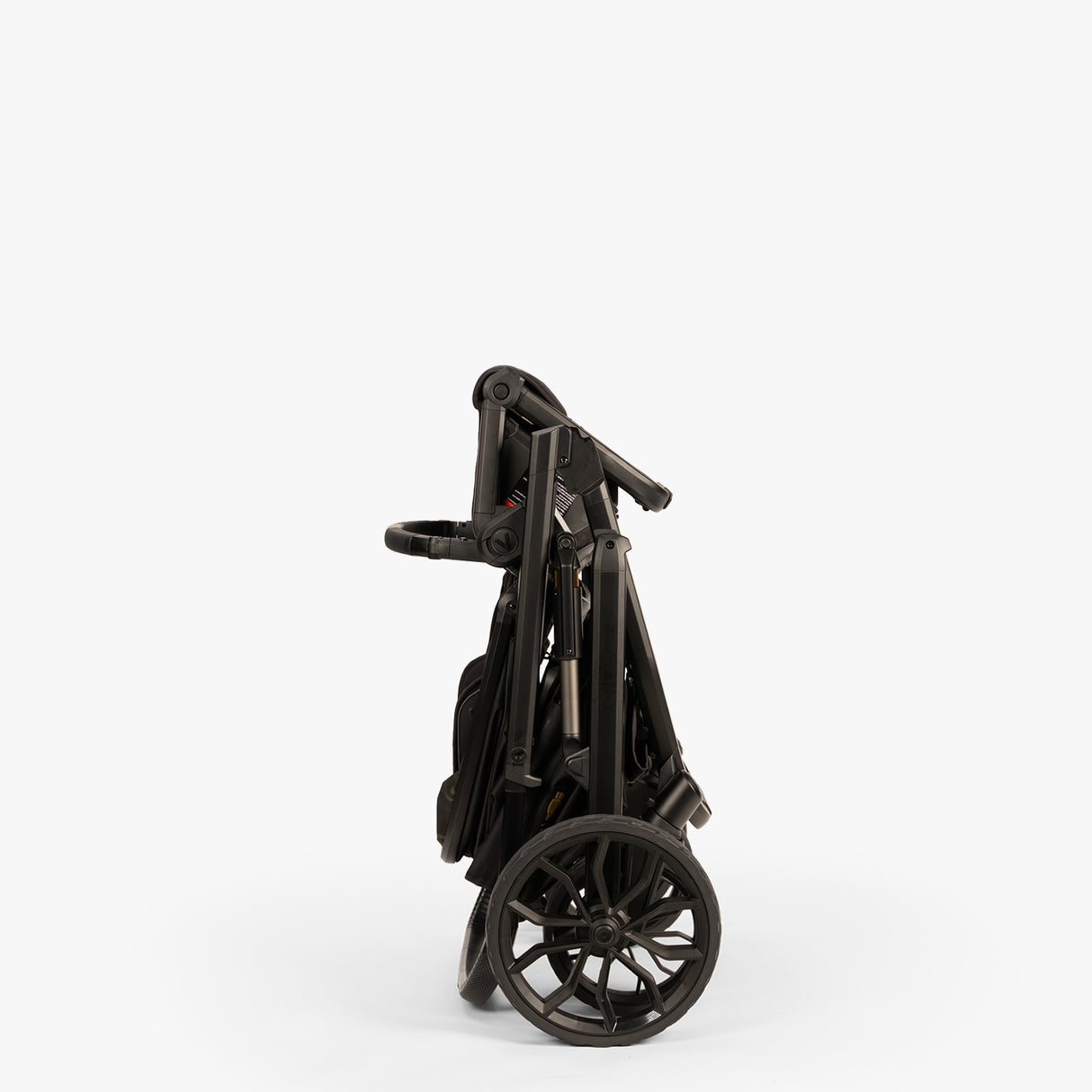 Folded TBG Veer Switchback Stroller in side view on a white background.