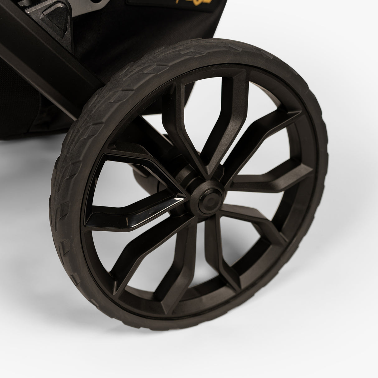Three-quarter top view of TBG Veer Switchback Stroller focusing on the wheel, showcasing rugged tire tread and durable design.