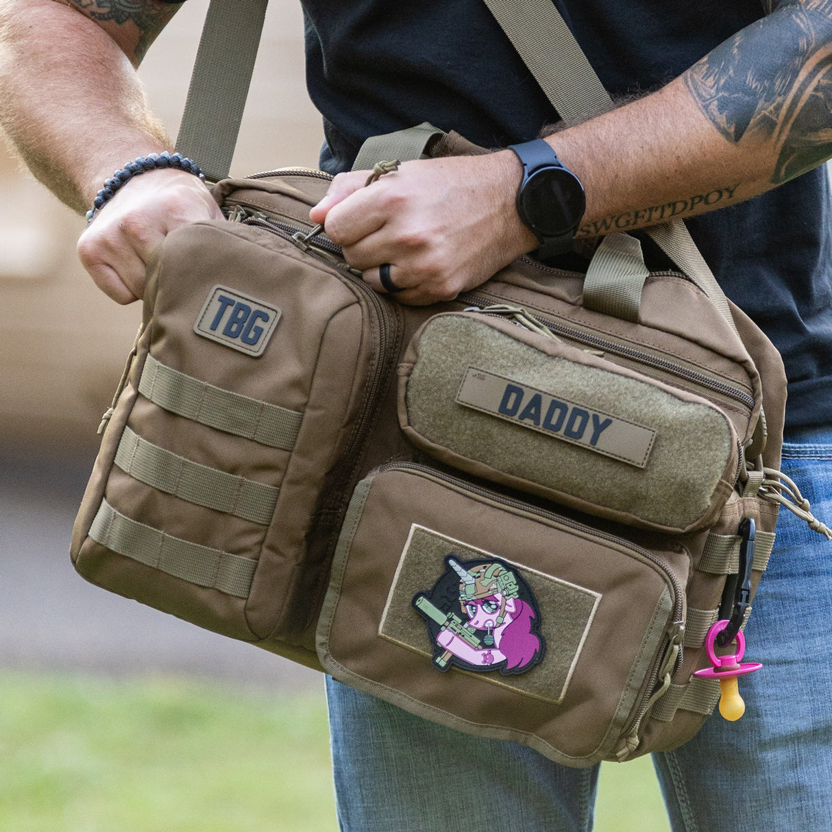 Tactical Unicorn Patch on a rugged diaper bag, showcasing a playful design for modern parents.