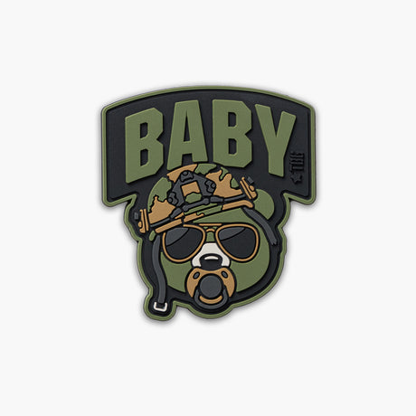Green Baby Bear face with pacifier, tactical helmet, and sunglasses. Word BABY above face.