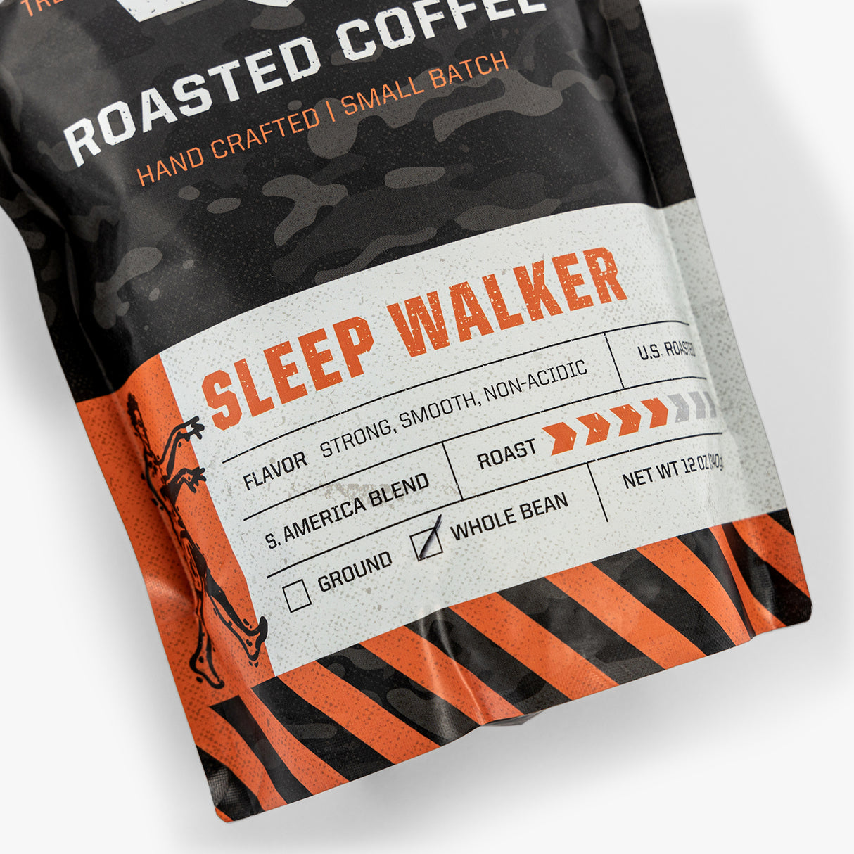 Rugged black and orange coffee bag labeled "Sleep Walker," handcrafted, whole bean, strong, smooth, non-acidic, U.S. roast.