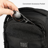 Hand placing sunglasses into the convenient accessory pocket of the Tactical Baby Gear Daypack Mini + Mat.