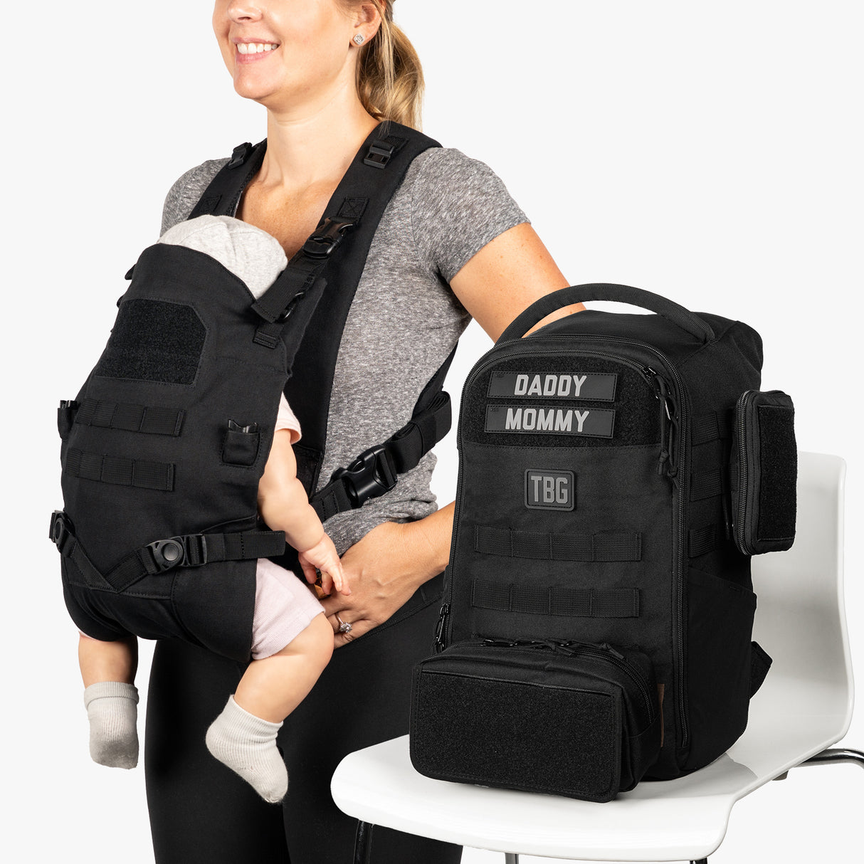 Mini diaper bag and baby carrier bundle featuring a sleek black design, perfect for modern parents on the go.