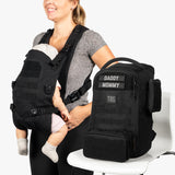 Mini diaper bag and baby carrier bundle featuring a sleek black design, perfect for modern parents on the go.