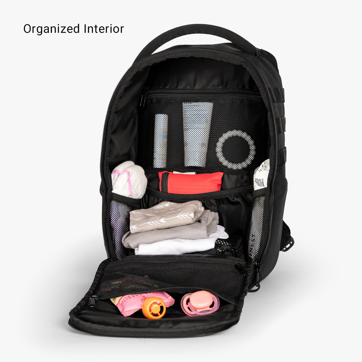 Mini diaper bag backpack with organized interior, featuring compartments for diapers, wipes, and baby essentials.