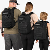 Three people wearing Tactical Baby Gear Mini Diaper Bag Backpacks in black, showcasing rugged design and practicality.