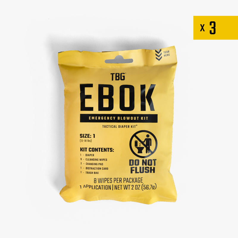Tactical Baby Gear EBOK diaper changing kit in yellow packaging, includes wipes, cleansing pad, and distraction card.