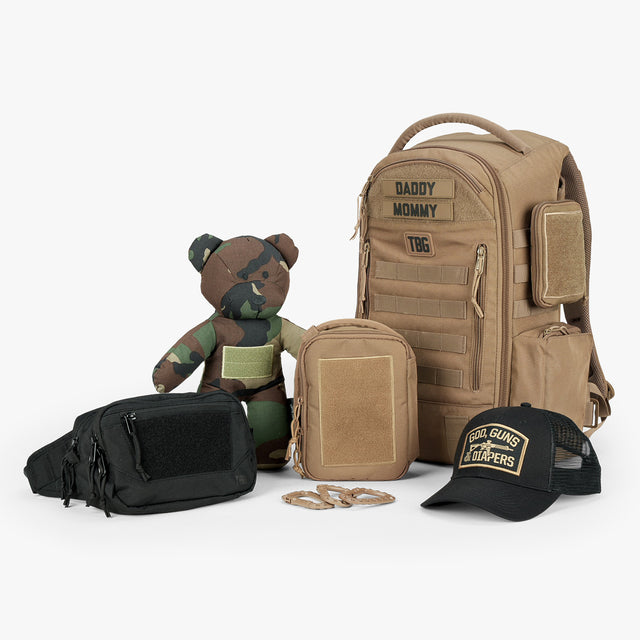 Tactical Baby Gear Father's Day Loadout featuring a tan backpack, black fanny pack, camo teddy bear, and cap.