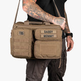 Rugged Deuce Diaper Bag in tan, featuring customizable name patches and multiple storage compartments for parents on the go.