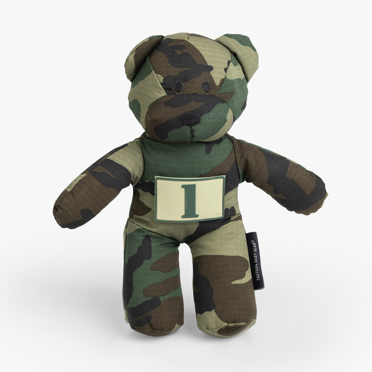Camo-patterned teddy bear with a number patch, designed for rugged parenting and playful adventures.