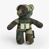 Camo-patterned teddy bear with a number patch, designed for rugged parenting and playful adventures.