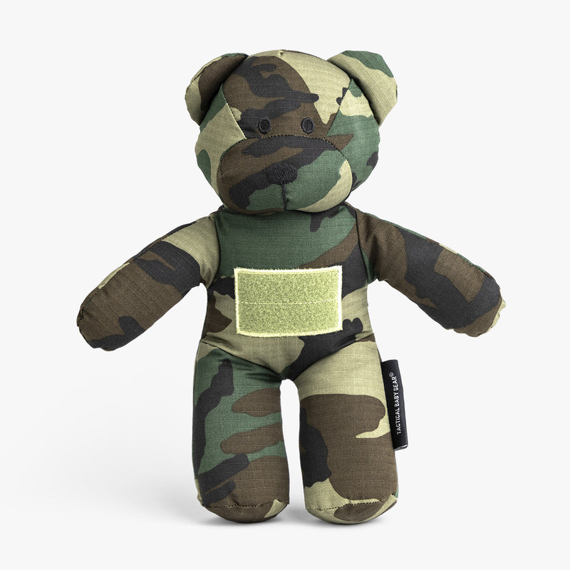 Camo-patterned teddy bear designed for kids, featuring a military-inspired look and a Velcro patch for personalization.