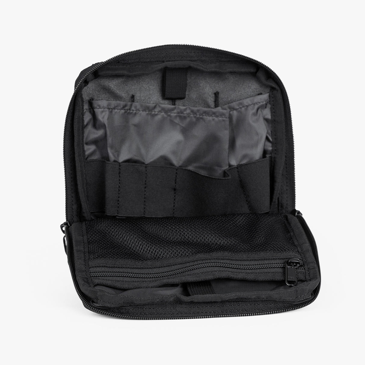 Open Tactical Utility Pouch featuring multiple compartments and elastic straps for organized storage of gear and essentials.