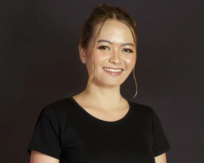 Person wearing a black shirt against a dark background