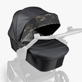 Black military-style stroller with camouflage canopy and white frame.