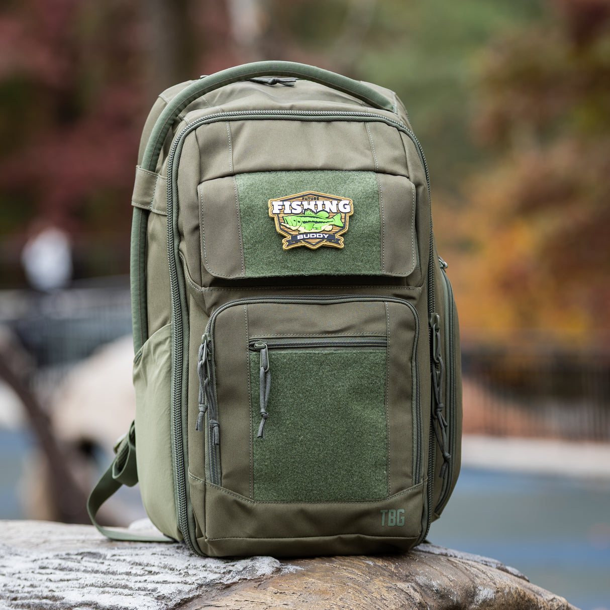 Rugged green backpack featuring a "Fishing Buddy" patch, designed for outdoor enthusiasts and parents.