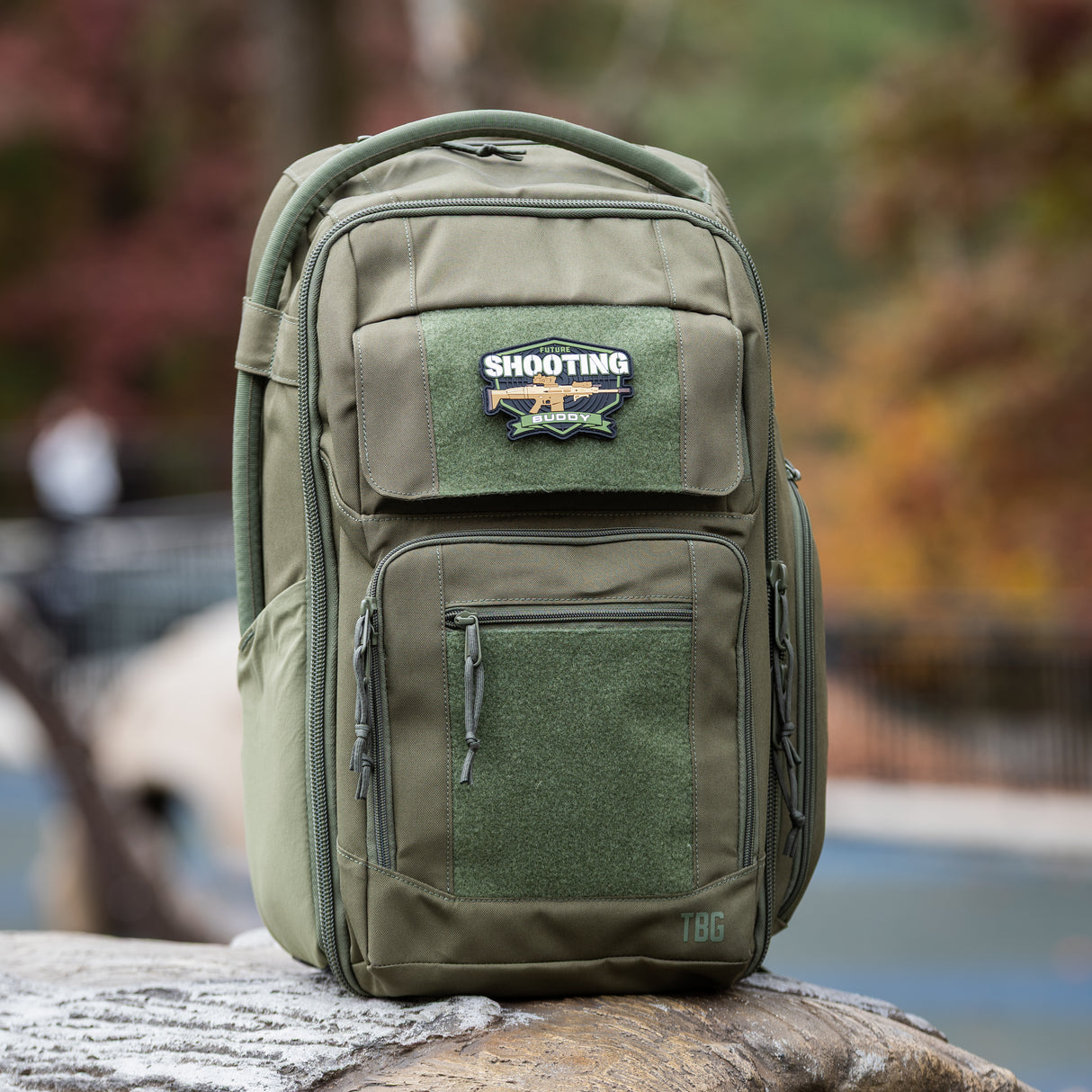 Rugged green backpack featuring a Shooting Buddy patch, designed for tactical parenting and outdoor adventures.