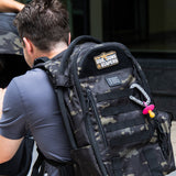 Tactical Baby Gear backpack featuring a "God, Guns & Diapers" patch, designed for rugged parenting.