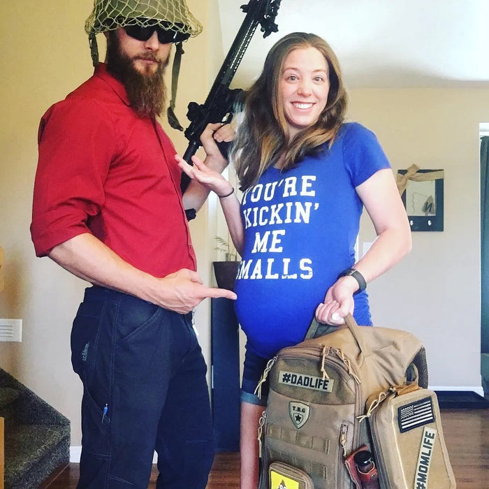 young pregnant couple with tactical diaper bag