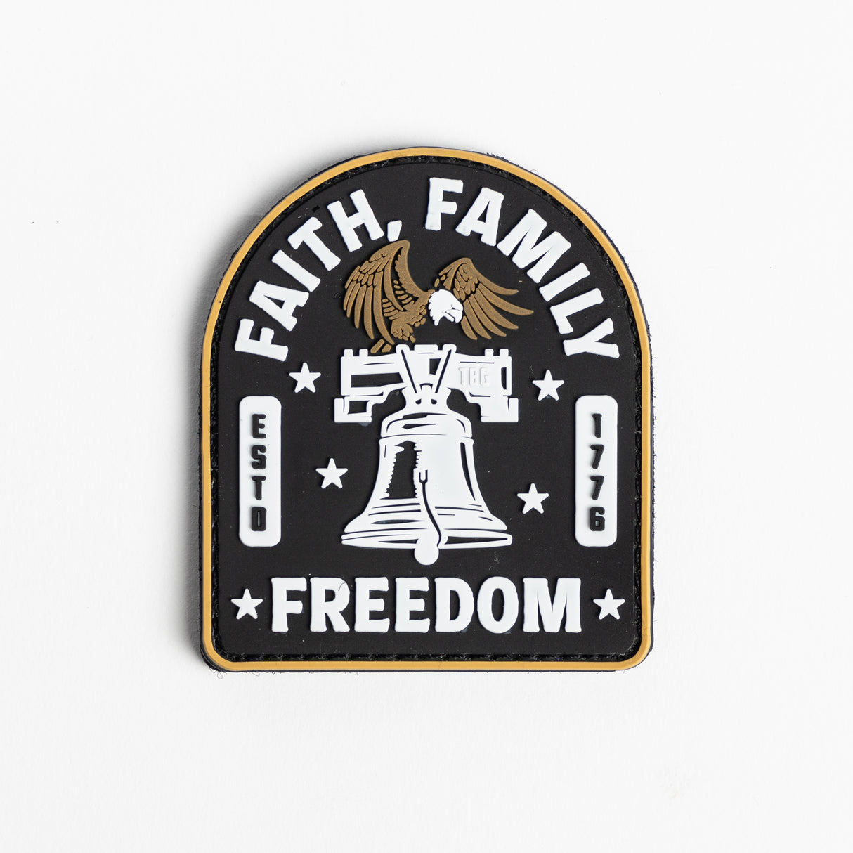 Embroidered patch featuring the words "Faith, Family, Freedom" in a circular design with an American flag motif in the background.