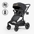 Black stroller with adjustable handlebar, sun canopy, and storage basket, shown with a car seat and accessories for newborn bundle.