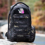 Tactical Unicorn Patch on a rugged black camo backpack, showcasing a playful yet tough design for parents.
