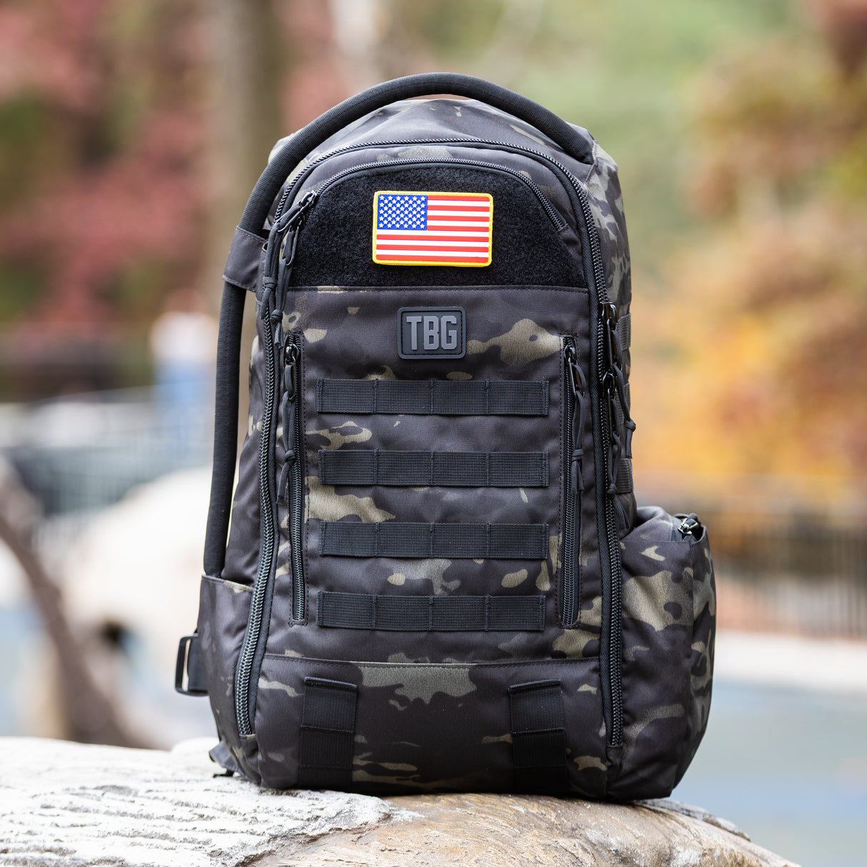 USA flag patch on a rugged black camo backpack, showcasing Tactical Baby Gear's military-inspired design.