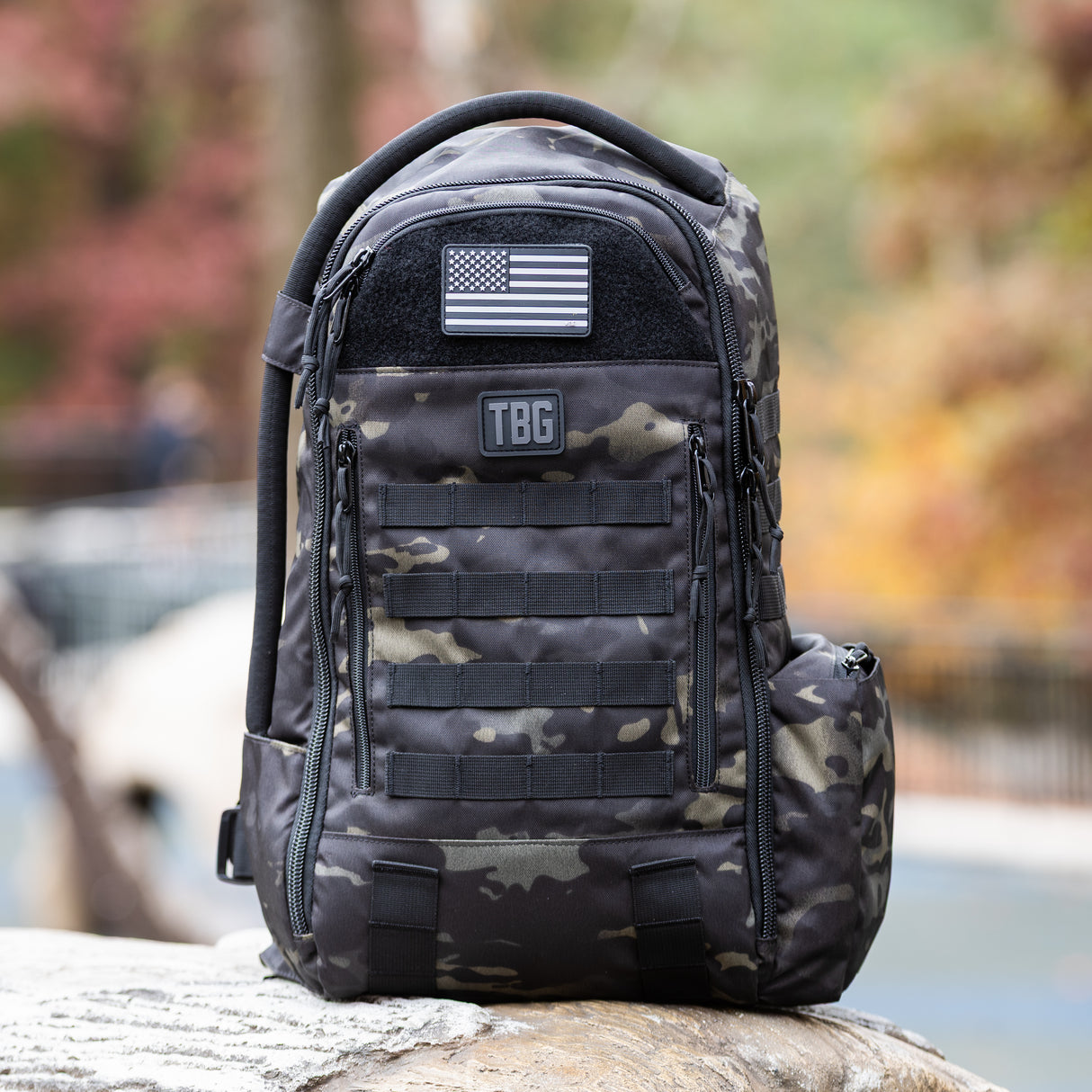 USA flag patch on a rugged black camo backpack, showcasing Tactical Baby Gear's military-inspired design.