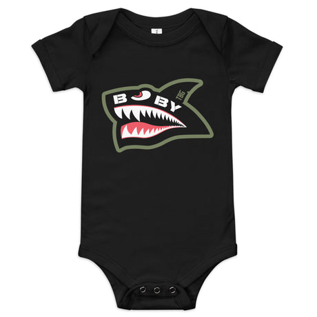 Black baby onesie with a bold, military-inspired shark face design, featuring red, white, and green accents.